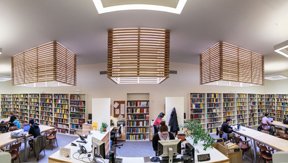 Eckhart Library interior, showing circulation desk, bookstacks and study tables