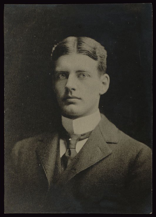 Young man with hair parted down the middle wearing high collar and tie