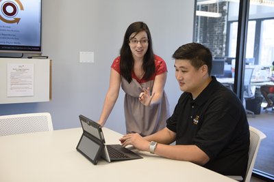 Librarian Emily Treptow (left) shows business resources to entrepreneur Andrew Kim, President of HaulHound.com, at the Polsky Innovation Exchange. (Photo by Joel Wintermantle)