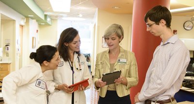 Biomedical librarian with faculty physicians and medical student