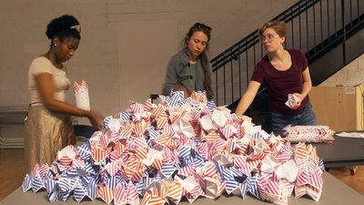 Three students prepare colorful fortune tellers