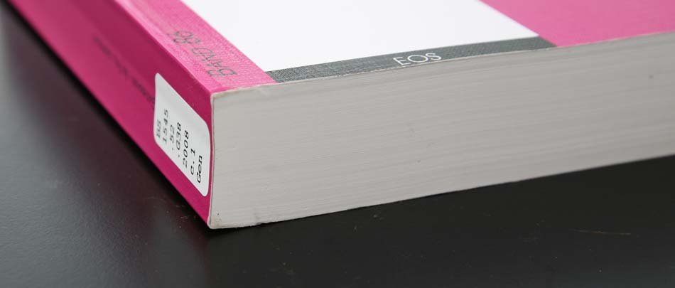 A pink book with a tight, clean glue binding.
