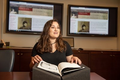 Ariadne Argyros with the web exhibit displayed behind her