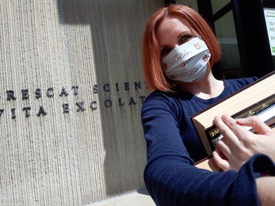 A woman holding books in front of Regenstein