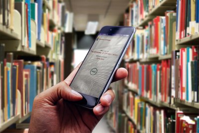 Checkout UChicago app on a phone in the bookstacks