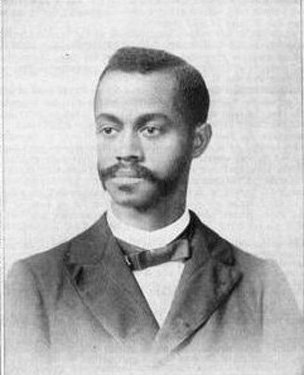 Headshot of an African-American man with a mustache.