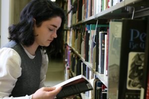 Student browsing the bookstacks.