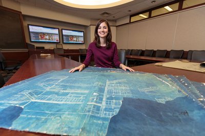 Special Collections Intern Ellen Ambrosone with blueprints