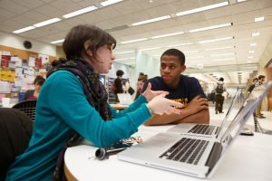 Two people with laptops