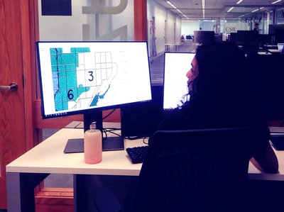 Student working on a map displayed on a computer monitor