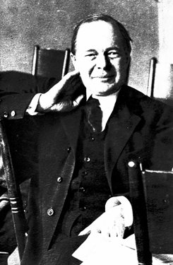 Headshot of a man leaning on his hand.