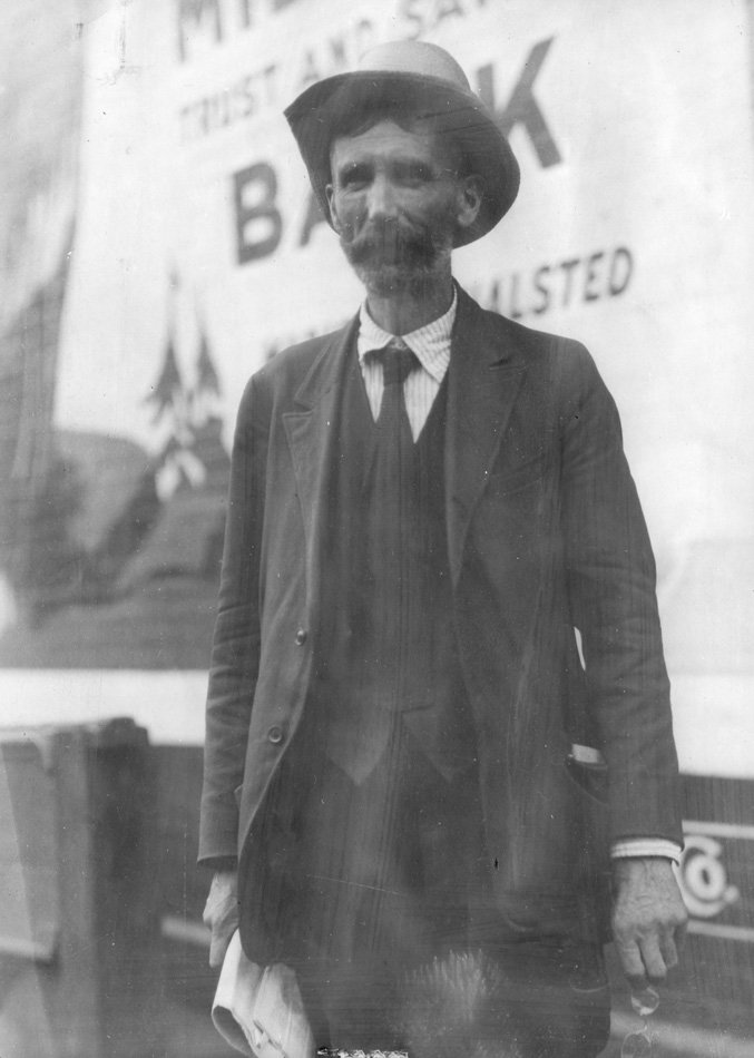 Photo of a man in a shabby suit, to represent a hobo