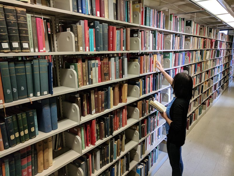 A student selects books from the stacks in Regenstein