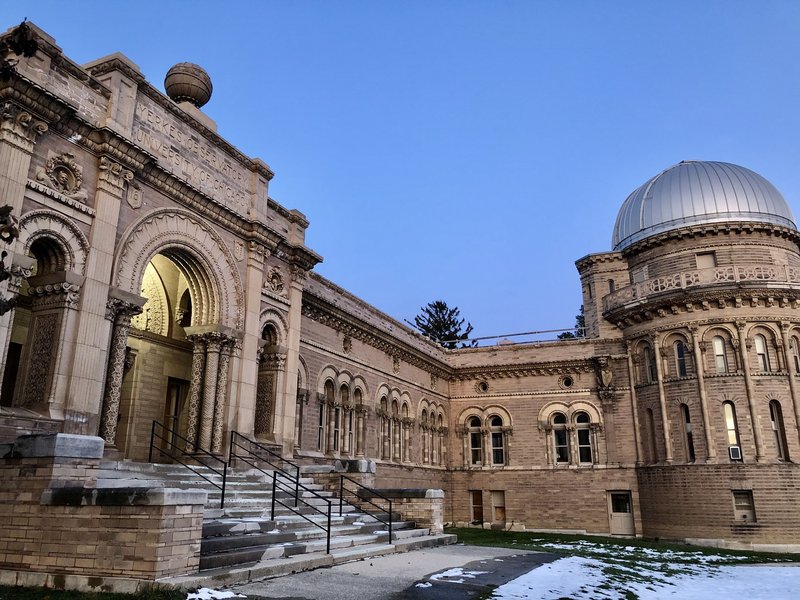 Exterior of Yerkes Observatory at dusk. The main entrance is at the left, with the small dome on the right.