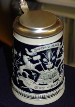 A beer tankard with the decoration of lions stirring a vat.