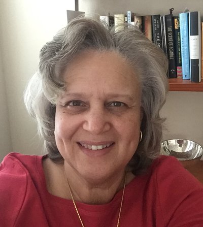 Juana Harper stands in front of books