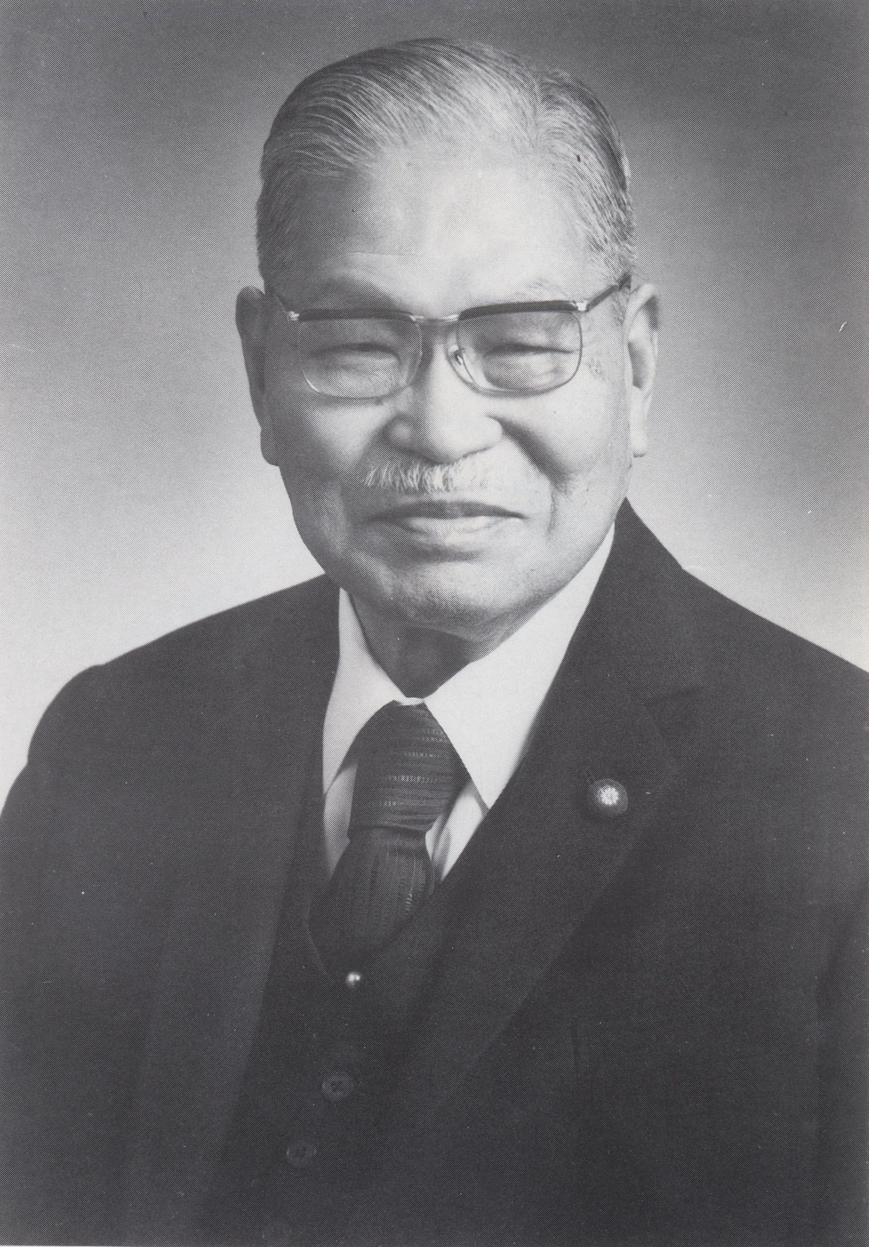 A black and white portrait of Kasai.