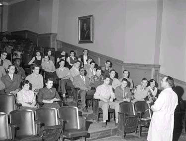 Students sit in a lecture hall.