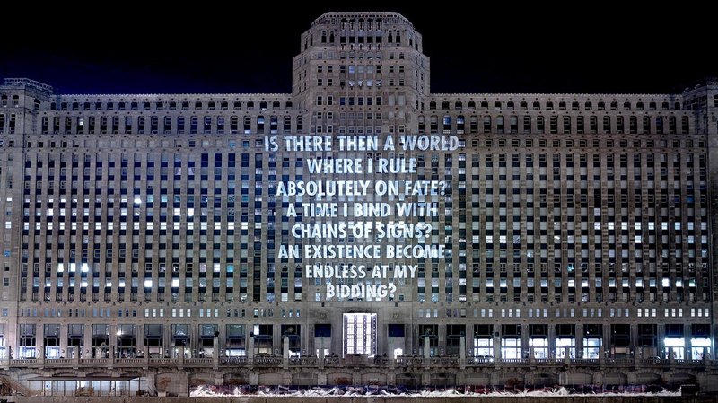 Photo of Merchandise Mart with projected text:  IS THERE THEN A WORLD WHERE I RULE ABSOLUTELY ON FATE? A TIME I BIND WITH CHAINS OF SIGNS? AN EXISTENCE BECOME ENDLESS AT MY BIDDING?