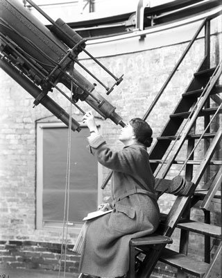 Mary Calvert looks into a large telescope