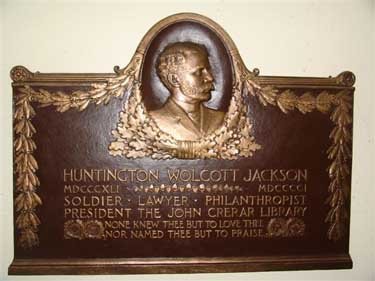 A golden plaque with a man's bust.