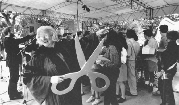 Photograph of President Gray launching an inflated phoenix balloon at the campus-wide party.