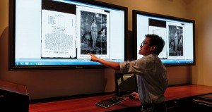 Graduate student points to image on screen