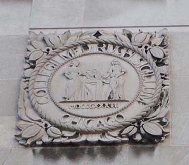 Photograph of a decorative stone emblem on a building.