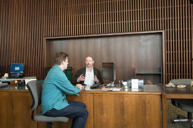 Librarian assisiting patron at circulation desk