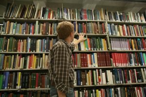 Person in bookstacks.