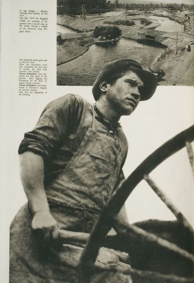 A worker pushes a wheelbarrow.