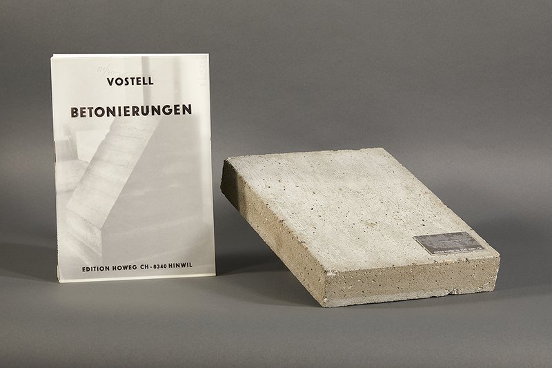A looseleaf portfolio of planned works in concrete and a concrete book.
