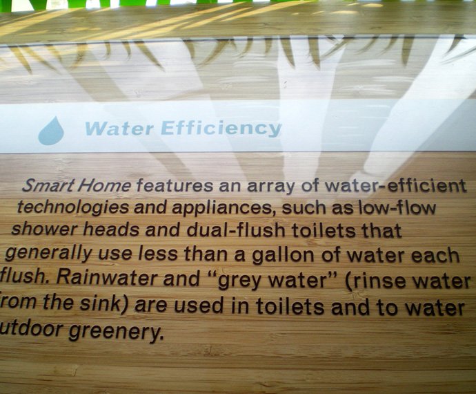 A picture of a large exhibit caption that discusses low-flow shower heads and dual-flush toilets.