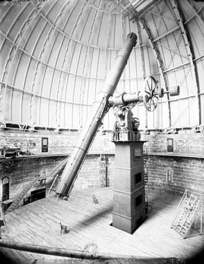 A huge telescope in a large round room.