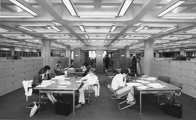 Black and white photo of students studying at tables in Regenstein Library