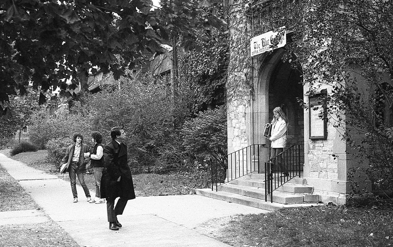 Four people standing outside the front door to The Blue Gargoyle