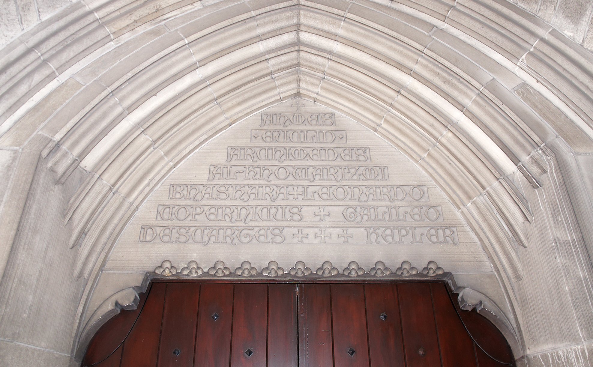 Photo of etchings of astronomers names over door in Eckhart Hall