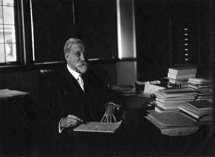 Photo of Chamberlin sitting at a desk