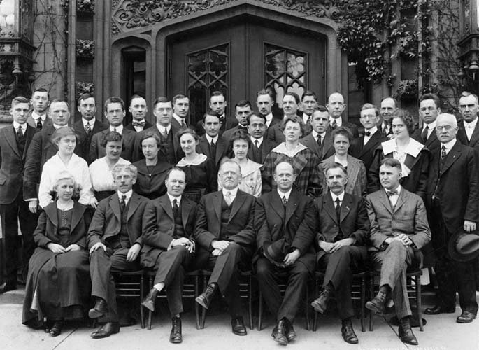 Professors pose for formal photograph.