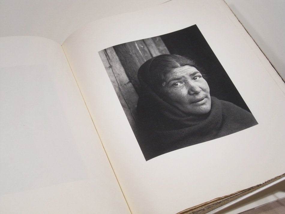 Book open to one black and white image of a native woman looking directly into the camera.