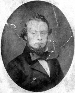 An old photograph of the same man as above, wearing a bowtie.