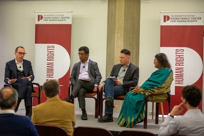 Four seated panelists discuss AI