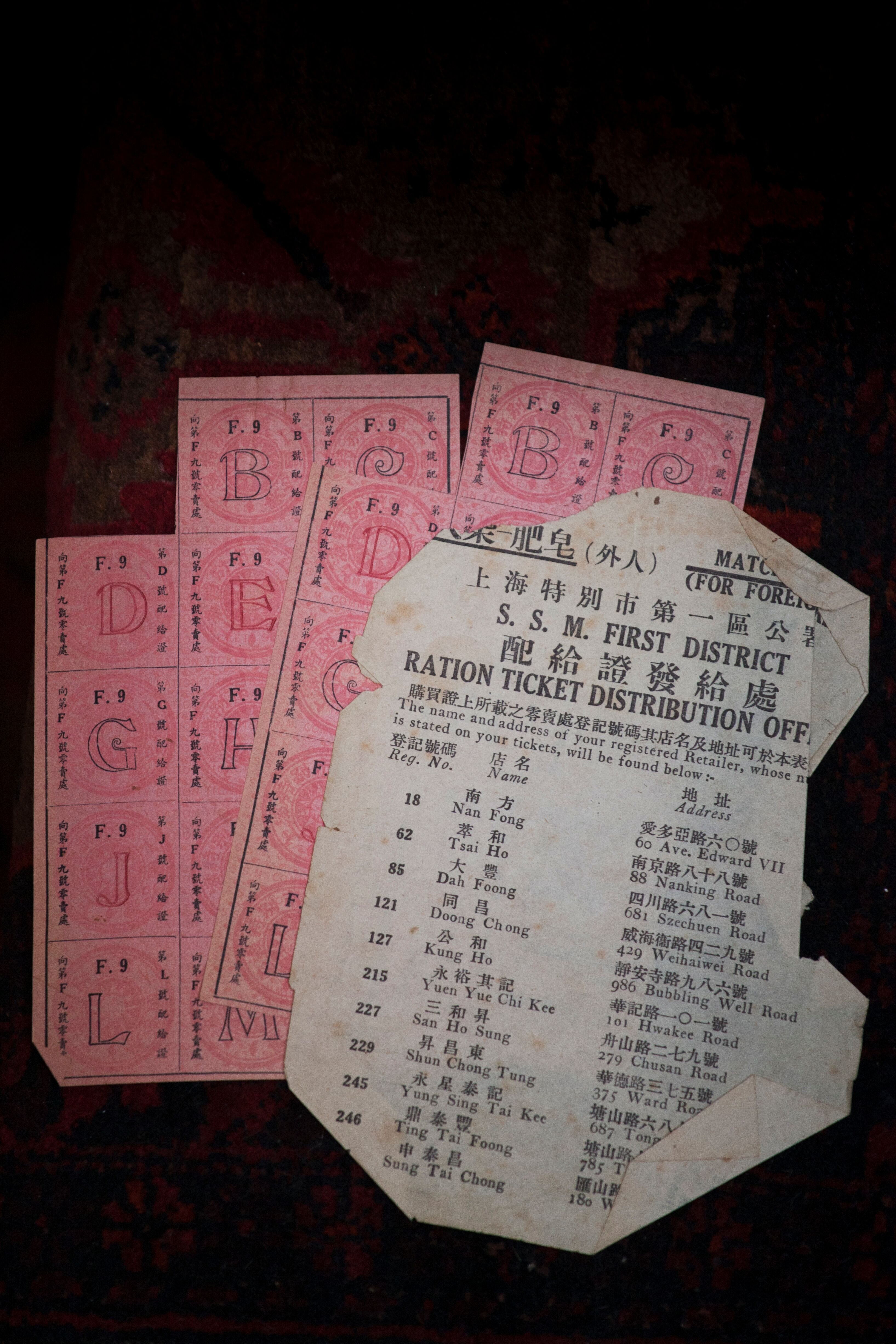 Pink and white slips with Chinese characters, listing different food retailers.
