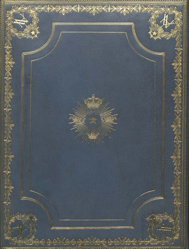 A photo of the navy blue back cover of Enrico Fermi's Nobel Prize, which has a starburst in the center and a detailed gold border