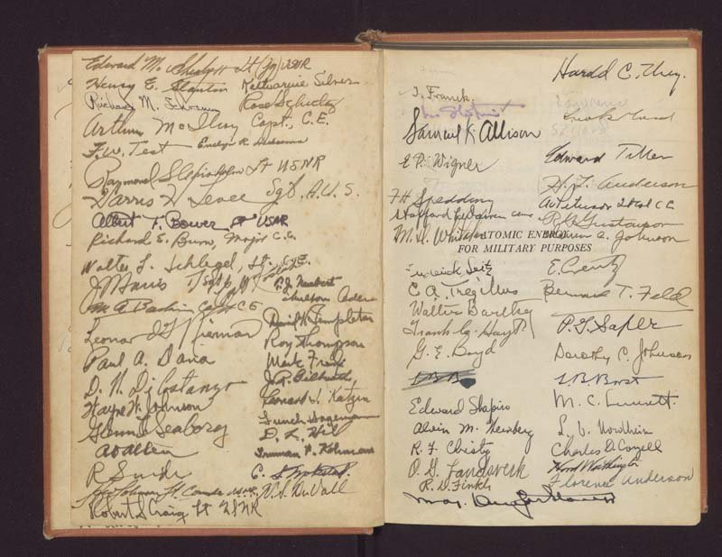The next two book pages covered in signatures, including the introductory title page reading, "Atomic Energy for Military Purposes," which has been written over in places by signatures.