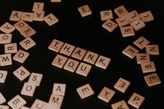 "Thank you" spelled using letter tiles