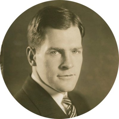 Black-and-white formal photographic portrait of Edward Foss Wilson, circa 1927-1934. He has short dark hair and is wearing a suit and tie.