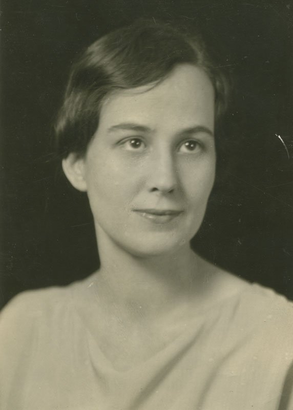 Black-and-white formal photographic portrait of Pauline Wyman Wilson. She is a young white woman with dark marcelled hair. She is shown from the shoulders up, and is wearing a light-colored dress with a draped neckline.