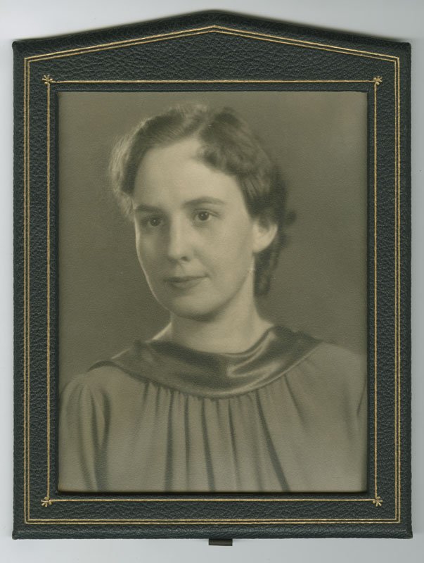 Black-and-white formal photographic portrait of Pauline Wyman Wilson wearing an academic robe. She is a young white woman with dark hair that is pinned up. She is shown in three-quarters profile from the shoulders up.
